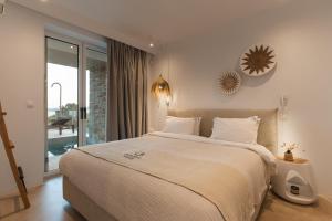 a bedroom with a large bed and a large window at Villa Ammos with Private Pool, Sauna & Seaview in Gialova +178 photos