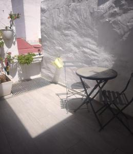 a table and two chairs sitting on a patio at Apartamentos Teresita in Badajoz