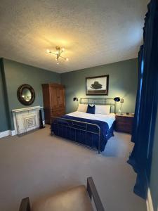 a bedroom with a large bed and a fireplace at Barrel House on Derby Row in Louisville