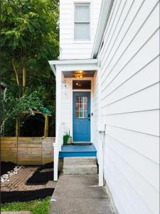 a blue front door of a white house at Barrel House on Derby Row in Louisville