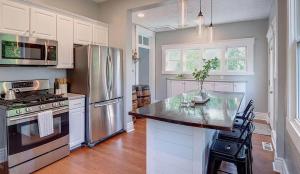 a kitchen with a stainless steel refrigerator and a counter at Barrel House on Derby Row in Louisville