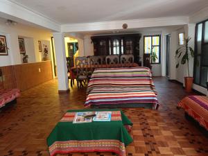 a living room with two beds and a table at Spanish Friends in Sucre