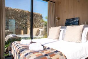 a bedroom with two beds and a large window at Sûr Jumigny in Jumigny
