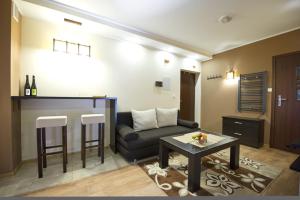 a living room with a couch and a table at Apartamenty-Plaza Zakopane in Zakopane