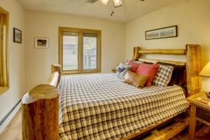 a bedroom with a large bed with a wooden headboard at Mountain Views + BBQs: Updated Cody Cabin in Cody
