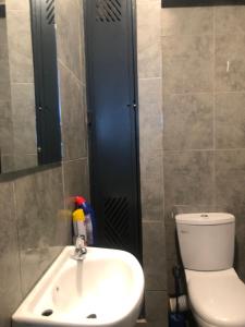 a bathroom with a sink and a toilet and a mirror at Tsavo Stanley, Kiambu La Mayan in Kiambu +18 photos