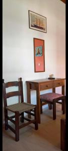 a wooden desk with a chair and a wooden bench at Revival rooms in Nikiana