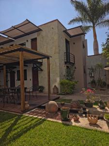 a house with a patio with a table and chairs at Maria Ines Hotel Suite in Oaxaca City