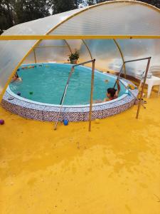 a pool in a tent with people in it at Perla Neagră Lotus Spa in Câineni-Băi