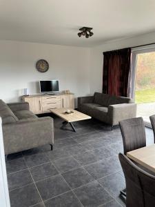 a living room with two couches and a table at LIPNO Hideaway in Kramolín