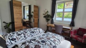a bedroom with a bed and a desk and a window at Auszeitplatzl in Unken