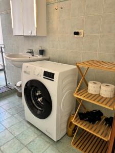 a washing machine in a bathroom with a sink at Trilocale a 100 m dal mare in Imperia