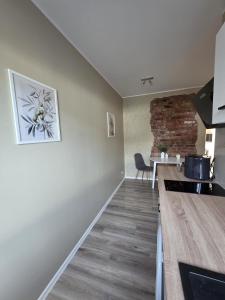 a kitchen with a counter and a dining room at Ülejõe Apartment with Free Parking in Pärnu