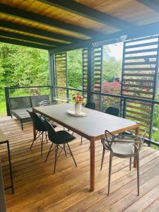 a table and chairs on a wooden deck at Garden Lodge Obervellach in Obervellach