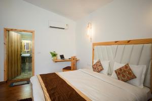 a bedroom with a large bed and a bathroom at Wildernest Resort in Kota Bāgh +11 photos