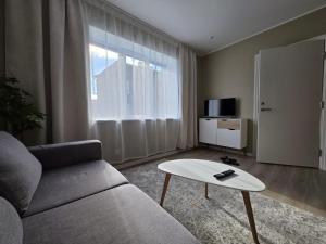 a living room with a couch and a coffee table at Ülejõe Apartment with Free Parking in Pärnu