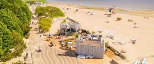 an aerial view of a beach with people and a building at Ülejõe Apartment with Free Parking in Pärnu