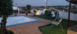 a swimming pool in a yard with a table and chairs at Villa Mares in Casas Novas de Marés