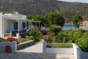 a house with flowers and a fire hydrant in front of it at Areti studios in Vathi