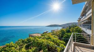 a view of the ocean from a balcony of a building at Blue Sea Apartments in Qeparo