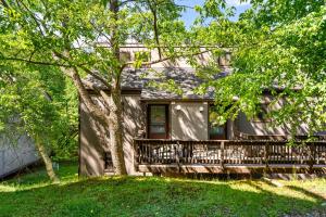 a house with a porch and a tree at Ski-OnSki-Off Camelback Arcade Pool in Tannersville