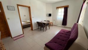 a living room with a couch and a table at Ege Apartments in Yalıkavak