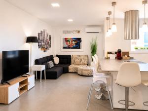 a living room with a black couch and a table at Seaside Apartment Retreat in Benicàssim
