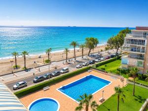 an aerial view of a pool and the beach at Seaside Apartment Retreat in Benicàssim
