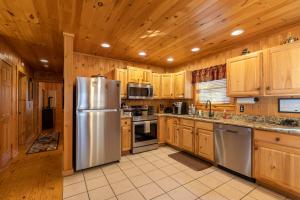 a kitchen with wooden cabinets and a stainless steel refrigerator at A Bears Hill in Boone