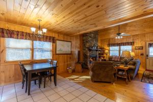 a living room with a table and a couch at A Bears Hill in Boone +22 photos