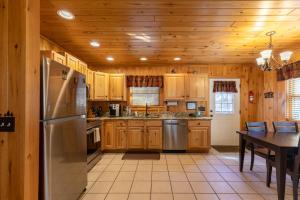 a kitchen with wooden cabinets and a stainless steel refrigerator at A Bears Hill in Boone