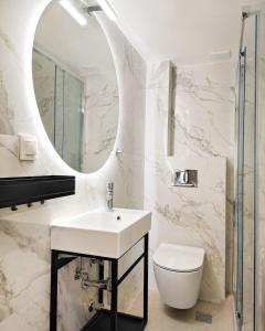 a white bathroom with a sink and a mirror at Siviri Sea & Forest-Cozy Apartment with Garden & Nature Views in Siviri +36 photos