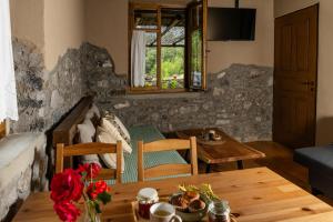 a living room with a table and a couch at PETRASTERO Mountain Retreat-Agrafa Evrytania Greece in Vérnikon