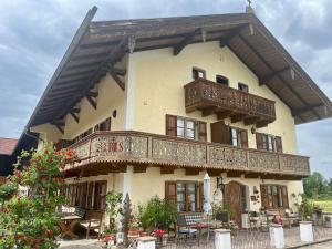 a large house with a balcony on top of it at Weissenhof | Chiemgau Karte in Rottau