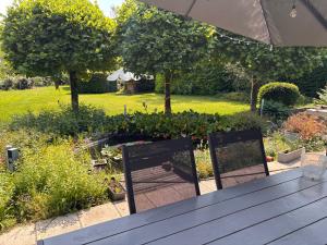 a table and two chairs in a garden at Selma hosts Tomorrowland 2026 in Duffel