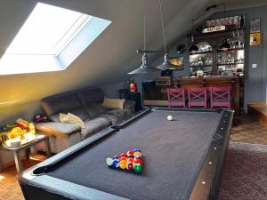 a living room with a pool table in the middle at Selma hosts Tomorrowland 2026 in Duffel +7 photos