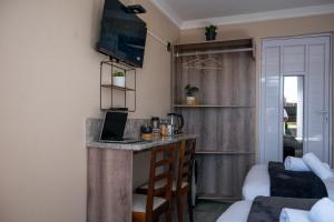 a small kitchen with a bar in a room at Infinity Home BnB in Leribe