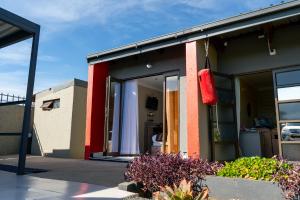 a house with a red bag on the side of it at Infinity Home BnB in Leribe