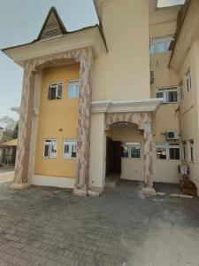 a large building with an archway in front of it at Hillmabliz Apartment in Abuja