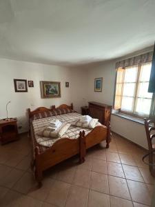 a bedroom with a wooden bed in a room at Albergo Passet in Pragelato