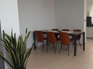 a dining room table with chairs and a plant at Apartment Spanjol in Banjol