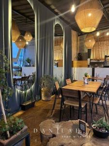 a dining room with a wooden table and chairs at Hotel Portal & Suites in Ciudad Hidalgo
