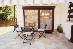 a patio with a table and chairs on it at Riverside Home Laura in Karlovac +37 photos