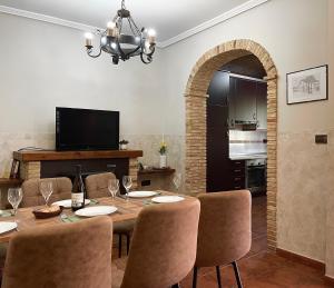 a dining room with a table and chairs and a television at Casa da Torre - Entre Galicia y Portugal in Rosal