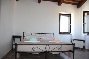 a bedroom with a bed with two towels on it at B&B del Borgo in Ortezzano