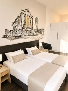 two beds in a room with a drawing on the wall at Apartment Modern City in Staré Mesto