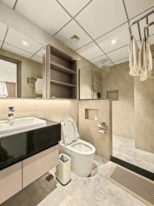 a bathroom with a toilet and a sink at Modera Residence Grand Phnom Penh, Serviced Apartments in Phnom Penh +65 photos