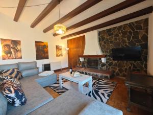 a living room with a couch and a fireplace at Villa Serra Brava mt Gemeinschatspool, 3 Apartments in Lloret de Mar
