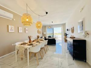 a dining room and kitchen with a table and chairs at Lilu Villa 1 with Private Pool and Seaview in Tigaki