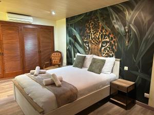 a bedroom with a bed with a mural of a leopard at Villa Serra Brava mt Gemeinschatspool, 3 Apartments in Lloret de Mar +63 photos